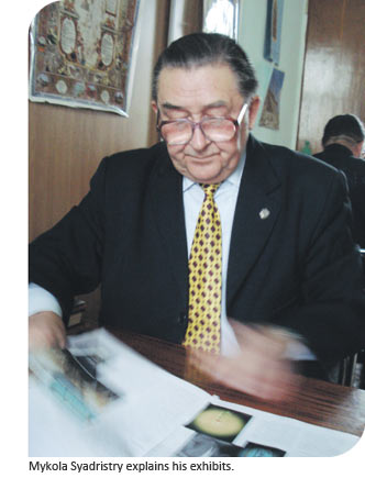 Mykola Syadristry explains his exhibits.